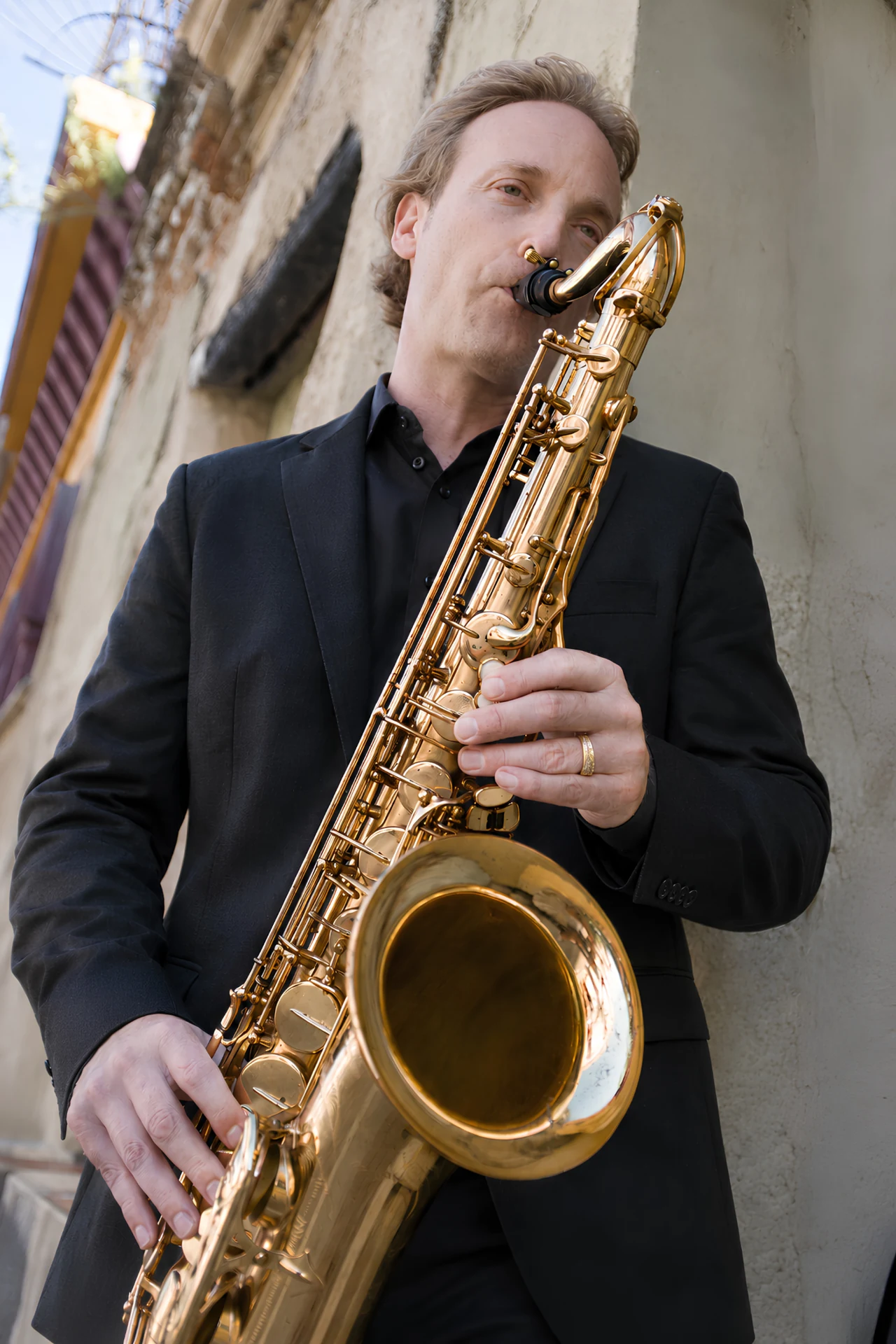 Howard Anderson playing tenor saxophone outdoors