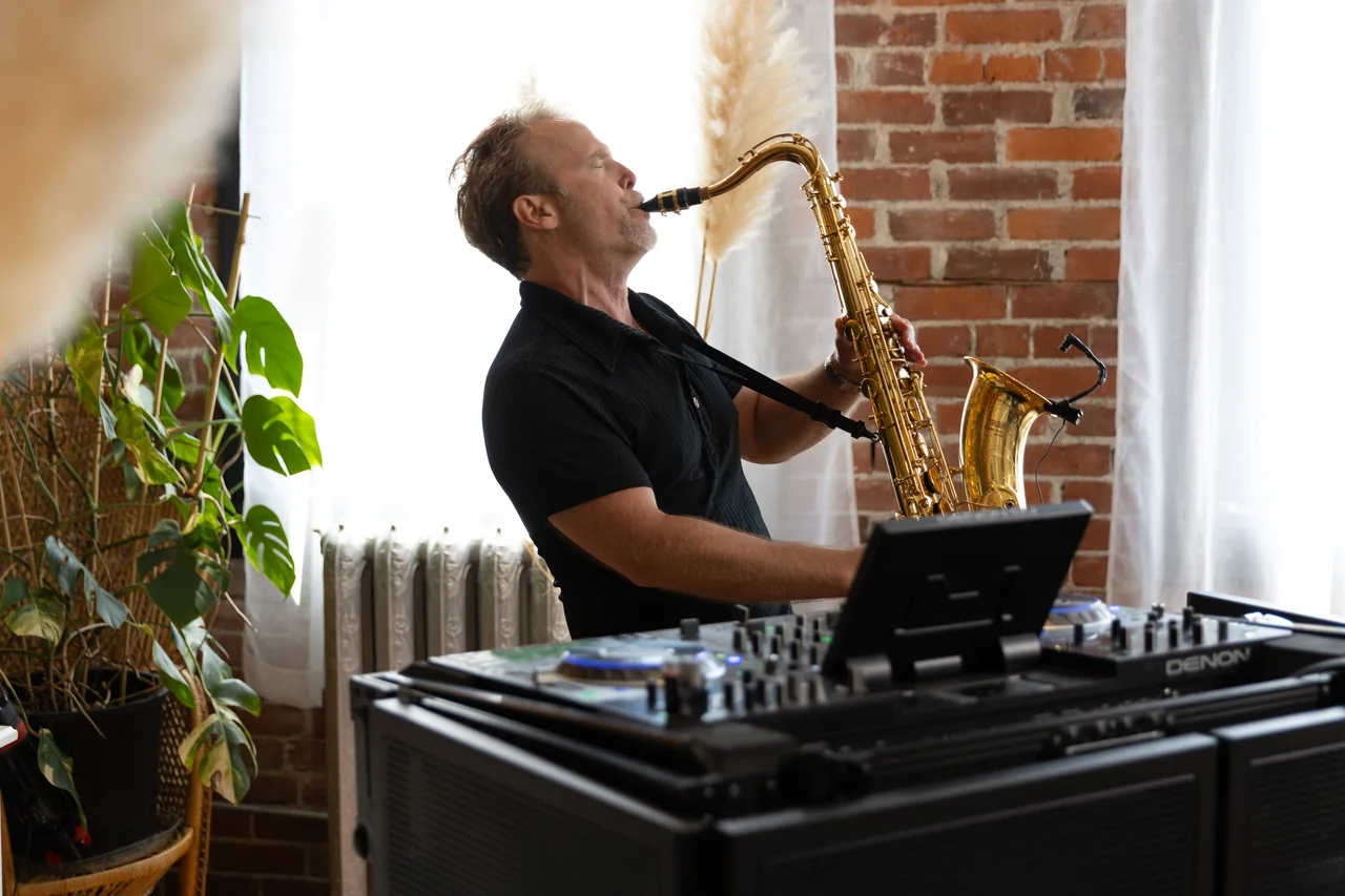 Howard Anderson performing saxophone in a bright loft setting