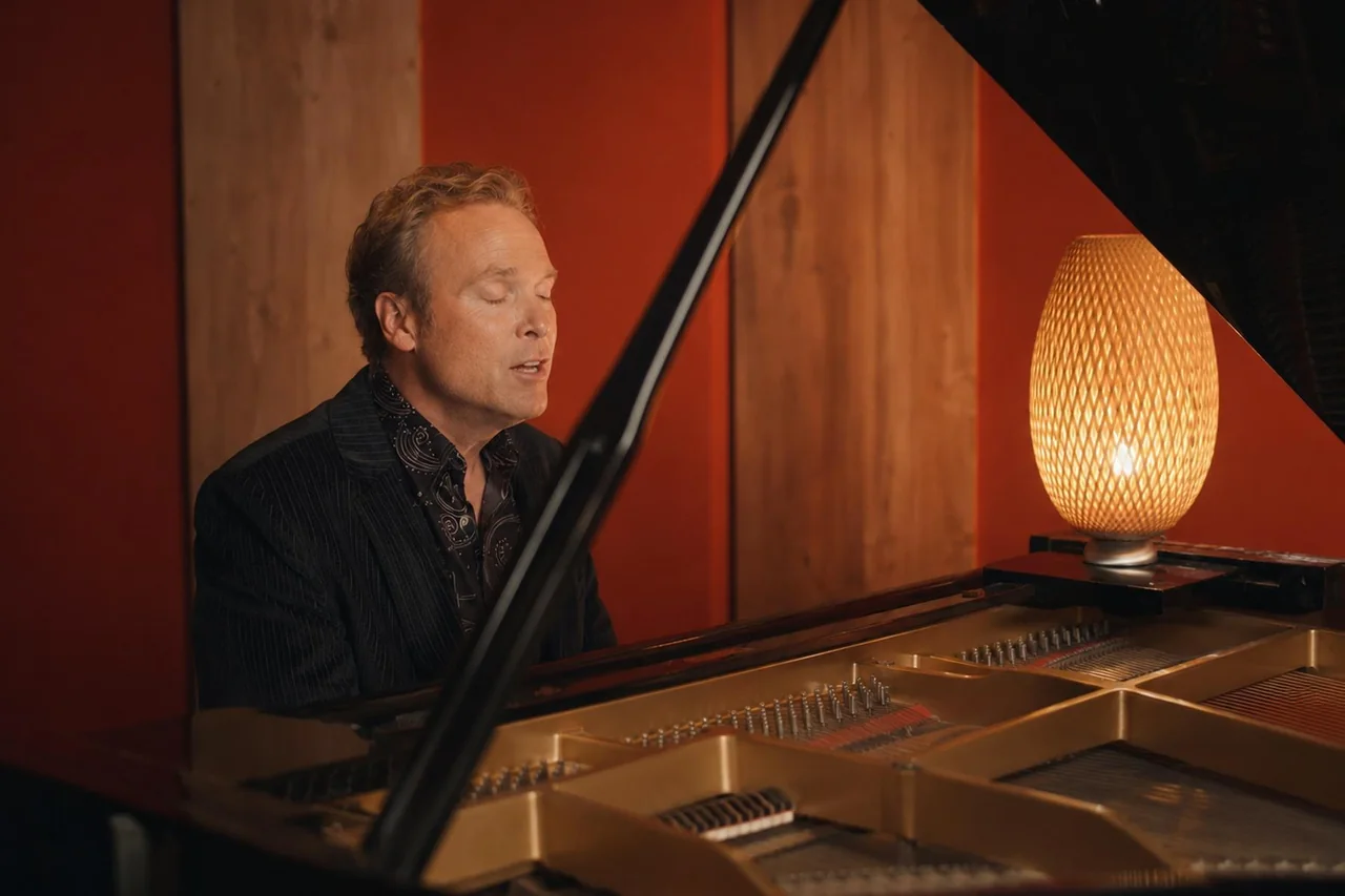 Howard Anderson singing while playing grand piano